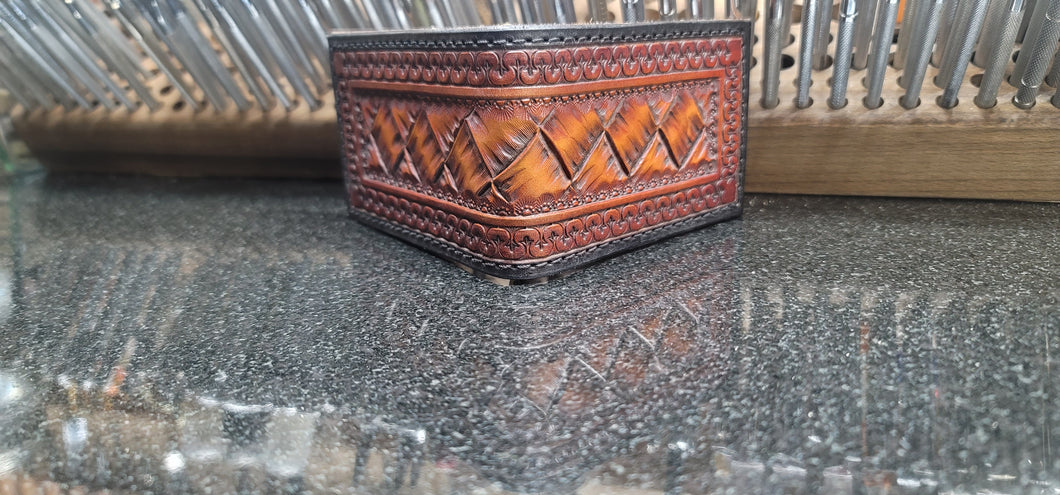 Money clip wallet with hand cut basket pattern.